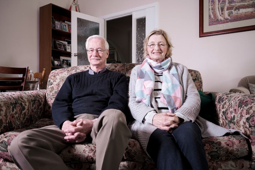 Alan and Helen Tyson sitting next to each other on a lounge