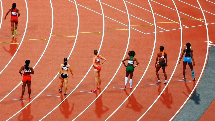 Women competing in a track and field race.