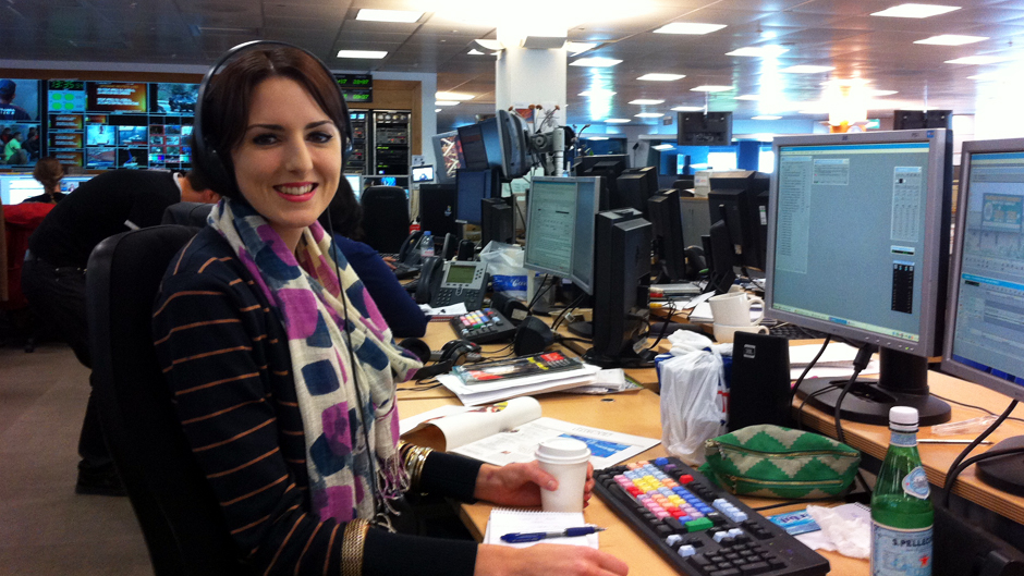 Imogen, wearing scarves and thick jumpers, at her desk at work in London, 2012.