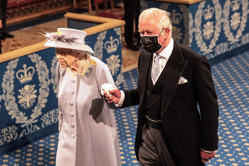 Prince Charles escorts the Queen through parliament.