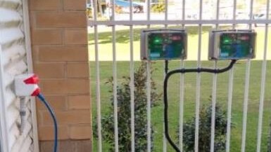 An air quality sensor fitted to a fence.