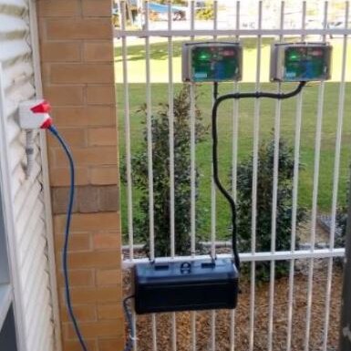 An air quality sensor fitted to a fence.