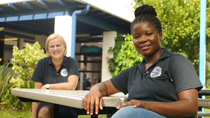 A photo of two St Vincent de Paul's employees, Fran Avon and Thereza Kagayo, sitting at a table.
