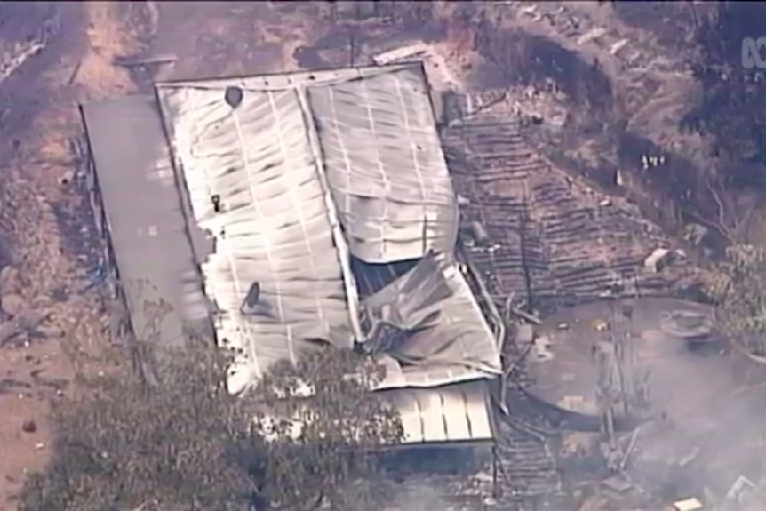 an aerial view of a collapsed an burnt house