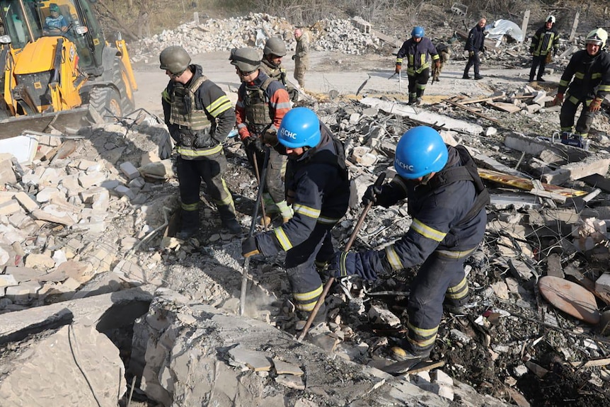 Emergency workers search the victims of the deadly Russian rocket attack. 