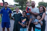 Chelsea Bond stands with her husband Matt and their five children on the street outside their house.