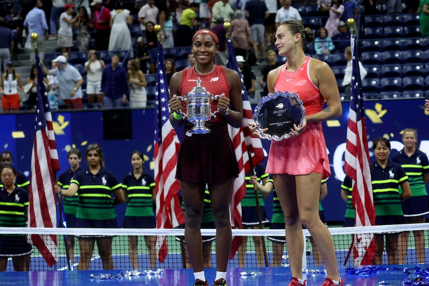 coco holds her trophy and aryna holds her runner-up plate 