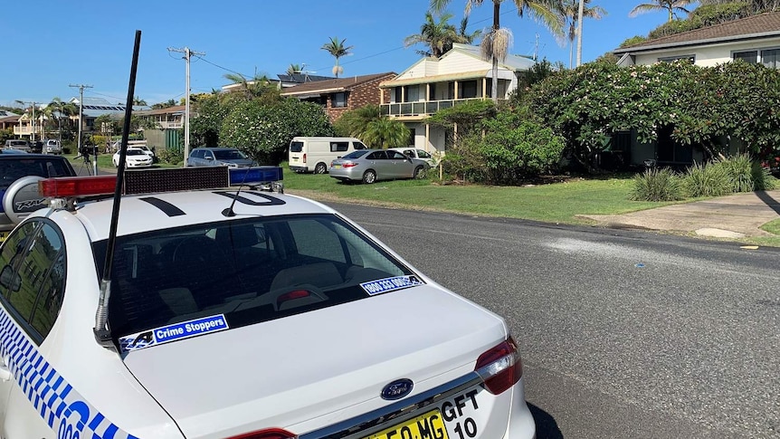 A police car parked in a suburban street