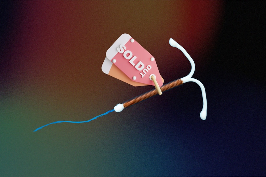 A t-shaped copper IUD in front of a dark background with a pink sold out tag attached.