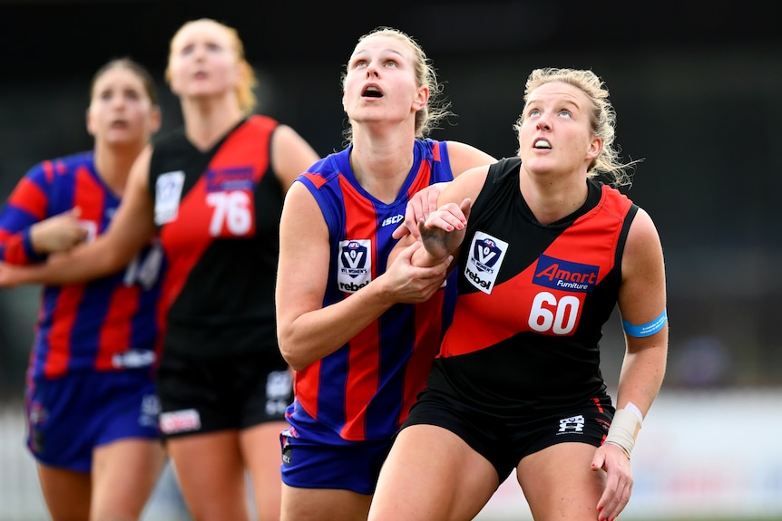 Kate Dudley of Port Melbourne and Jaimee-Lee Morrow of Essendon compete in the ruck.