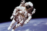 Astronaut floating in space above the Earth
