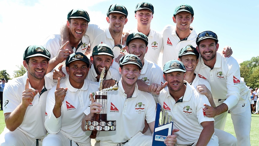 Australian cricket team poses with the Trans-Tasman Trophy after second Test in Christchurch