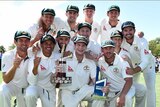 Australian cricket team poses with the Trans-Tasman Trophy after second Test in Christchurch