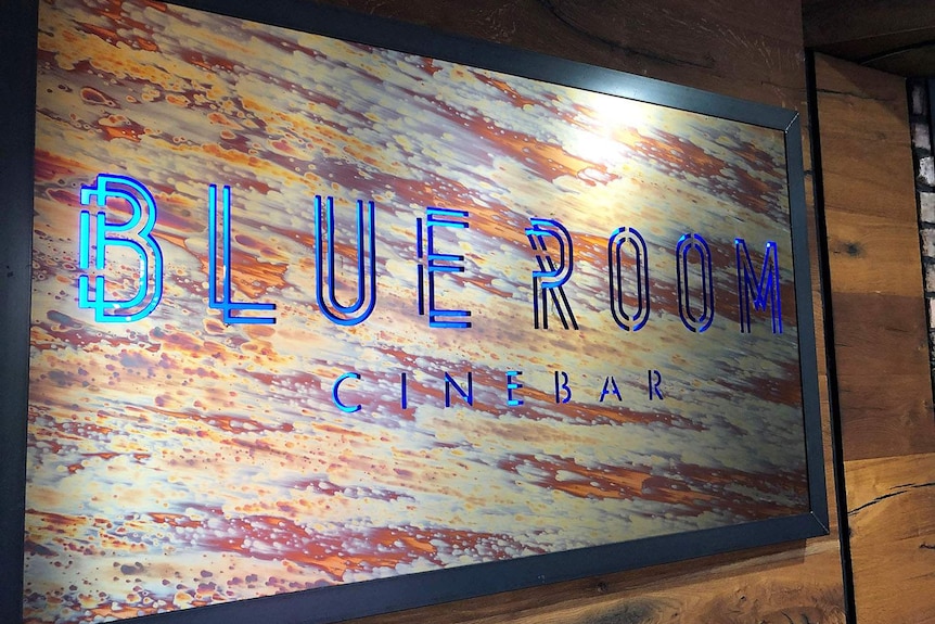 Glowing blue signage at entrance of Blue Room Cinebar, which has operated as a cinema, bar and restaurant since 2005.