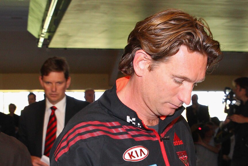 Bombers coach James Hird (R) and chairman David Evans leave the club's press conference at Windy Hill.
