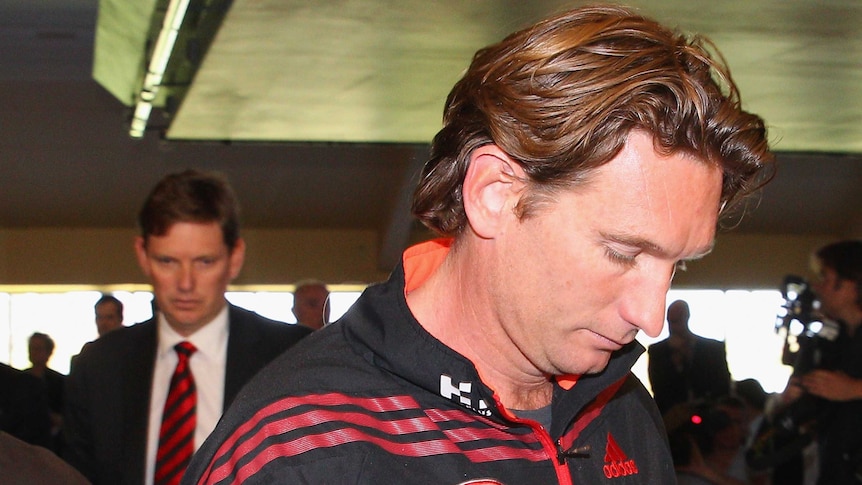 Bombers coach James Hird (R) leaves after a press conference on May 6, 2013.