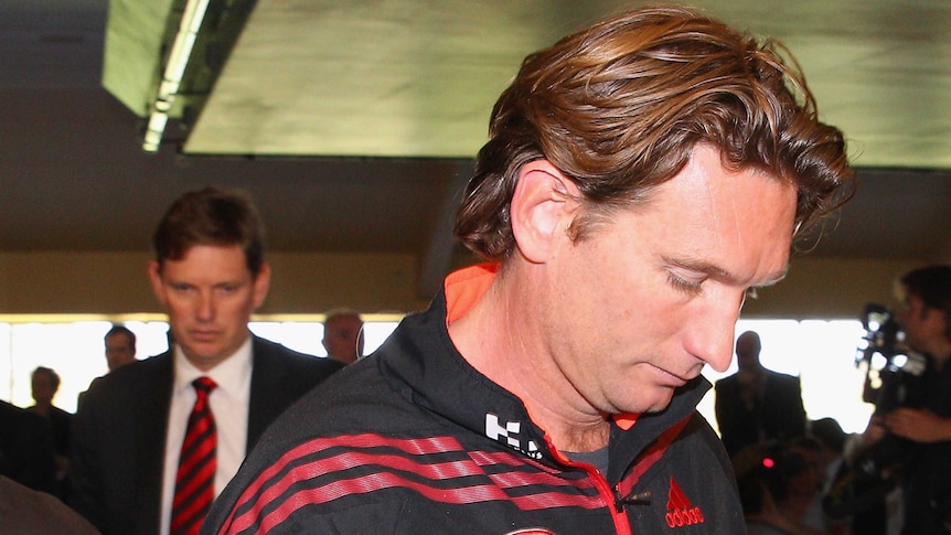 Bombers coach James Hird (R) and chairman David Evans leave the club's press conference at Windy Hill.