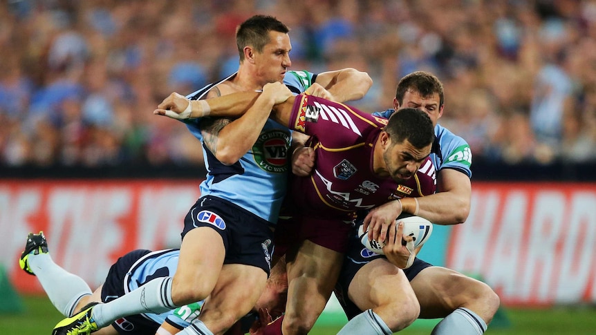 Greg Inglis is tackled during State of Origin III.