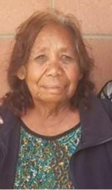 An older Aboriginal woman smiles at the camera.