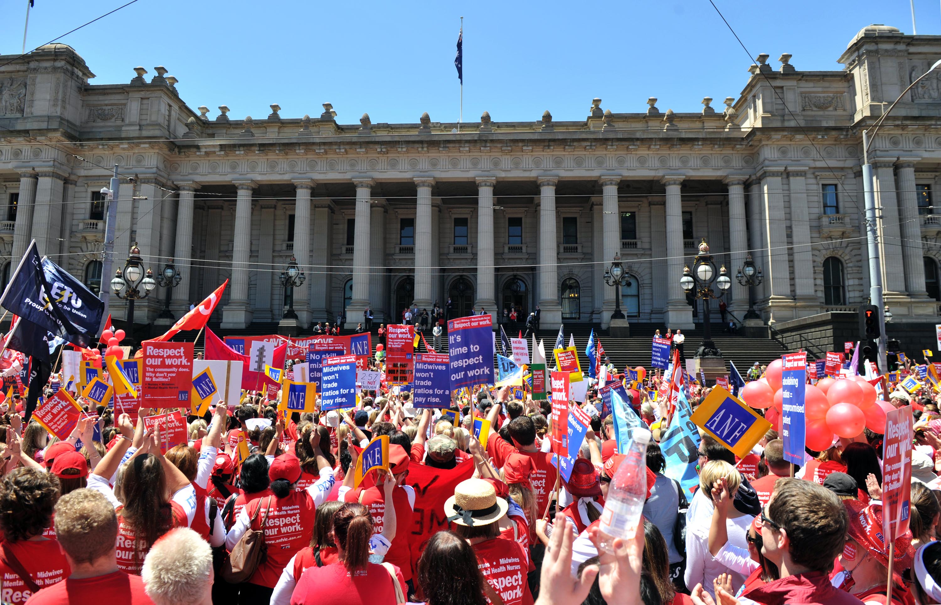 Nurses and supporting trade unionists rally outside Parliament House in Melbourne.