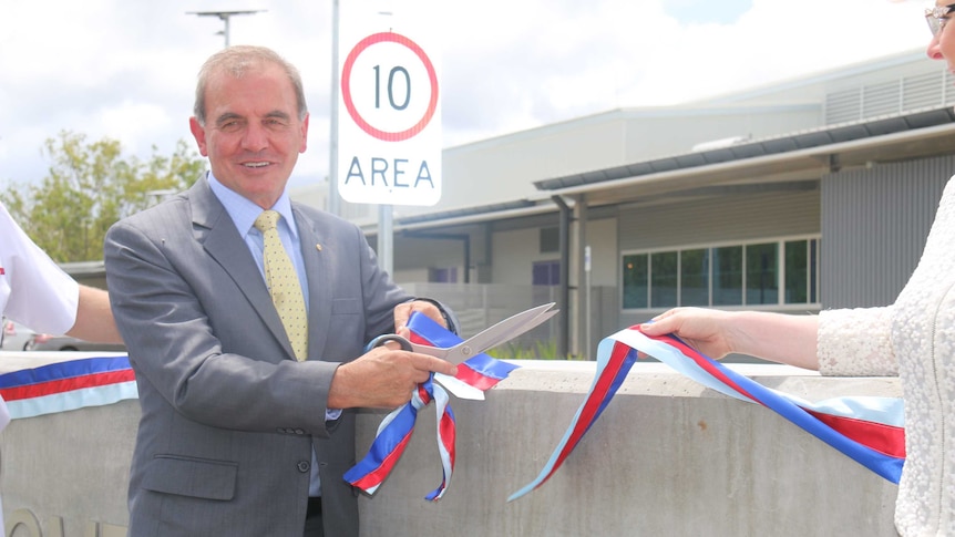 Retired Major General Peter Haddad cuts the ribbon at the official opening of new storage facility in Darwin