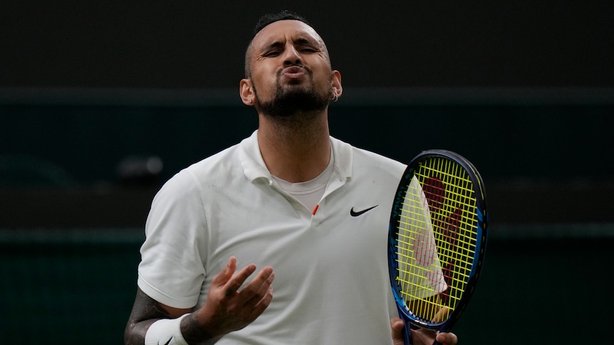 Nick Kyrgios grimaces with his eyes closed after a point during his first-round Wimbledon match.