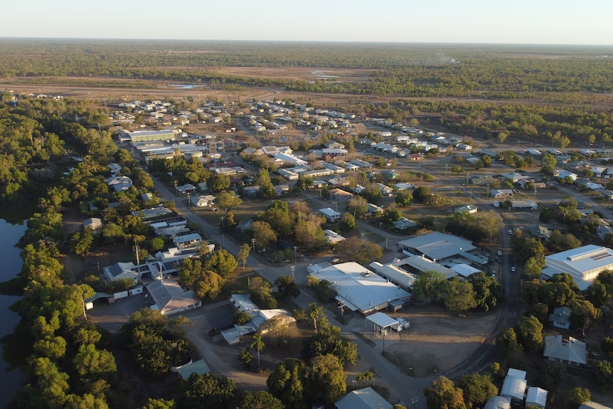 A small, outback town with a creek running through at sunset