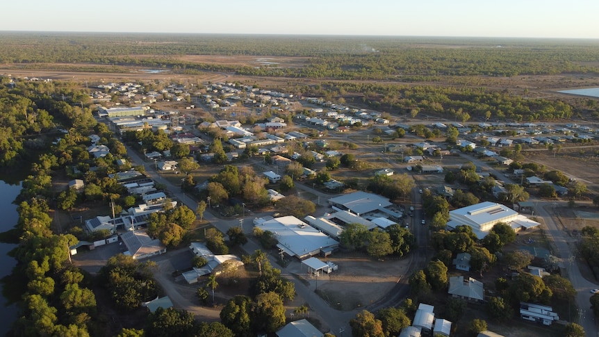 A small, outback town with a creek running through at sunset