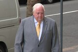 Clive Palmer walks into court 