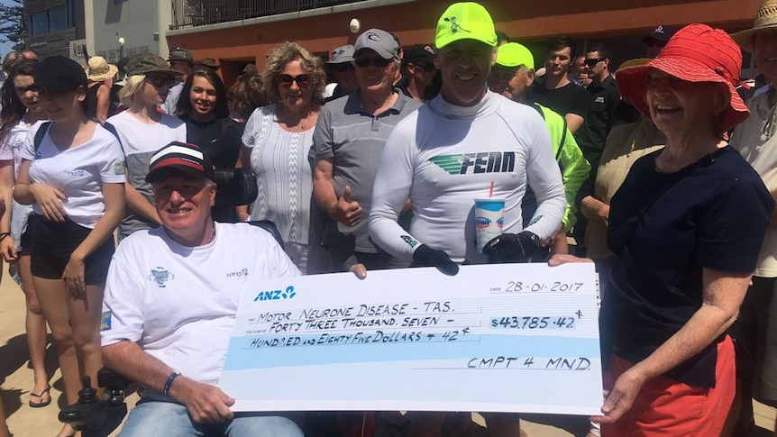 Kirk and Craig with the money raised for MND.