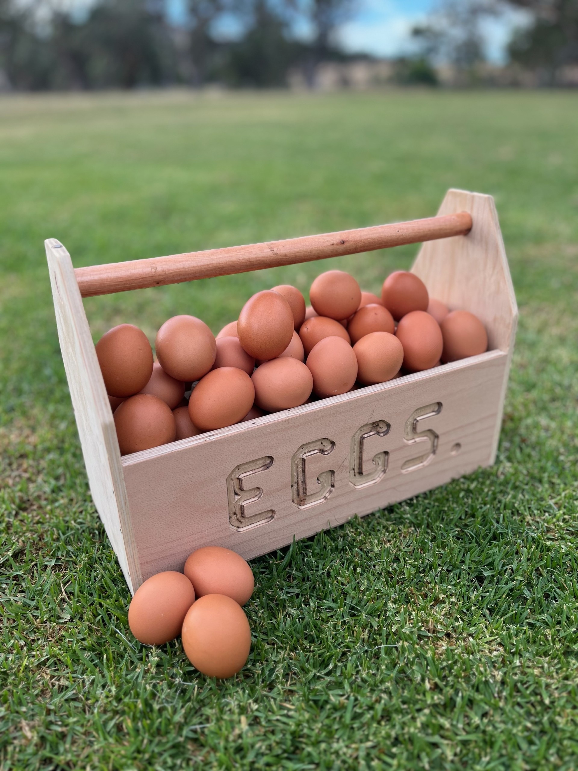 Un cubo de madera lleno de huevos.