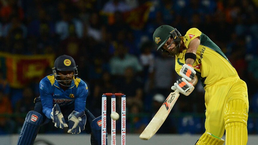 Australia's Glenn Maxwell hits another boundary as Sri Lankan keeper Kusal Perera looks on in T20
