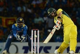 Australia's Glenn Maxwell (R) is watched by Sri Lankan keeper Kusal Perera as he hits a four in T20.