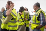 Brussels airport workers celebrate after the first flight took off.