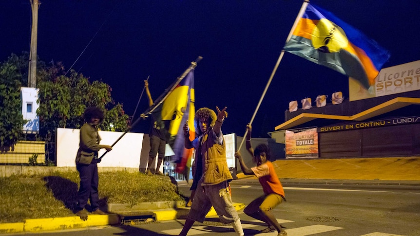 Pro-independence activists strike a pose as they celebrate in the streets of Noumea, New Caledonia's capital.