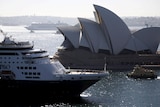 A cruiseliner nexts to the Sydney Harbour Bridge 