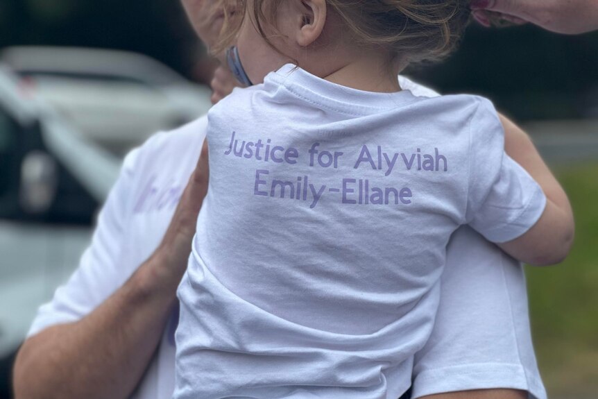 A young family member of Brooke Skinner wearing a shirt that reads "Justice for Alyviah Emily-Ellane." 