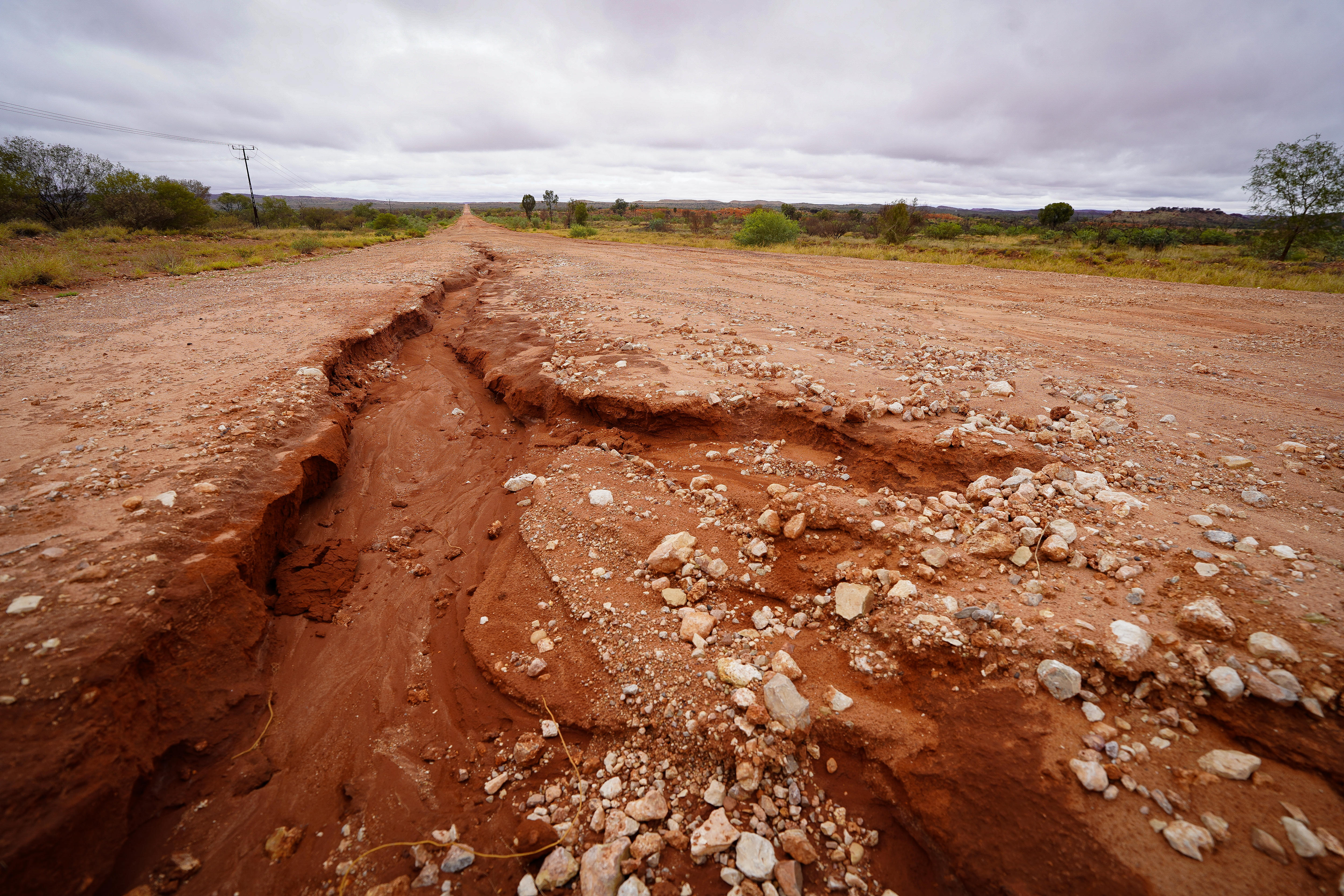 Parte de un camino de tierra roja fue arrasado por las inundaciones.