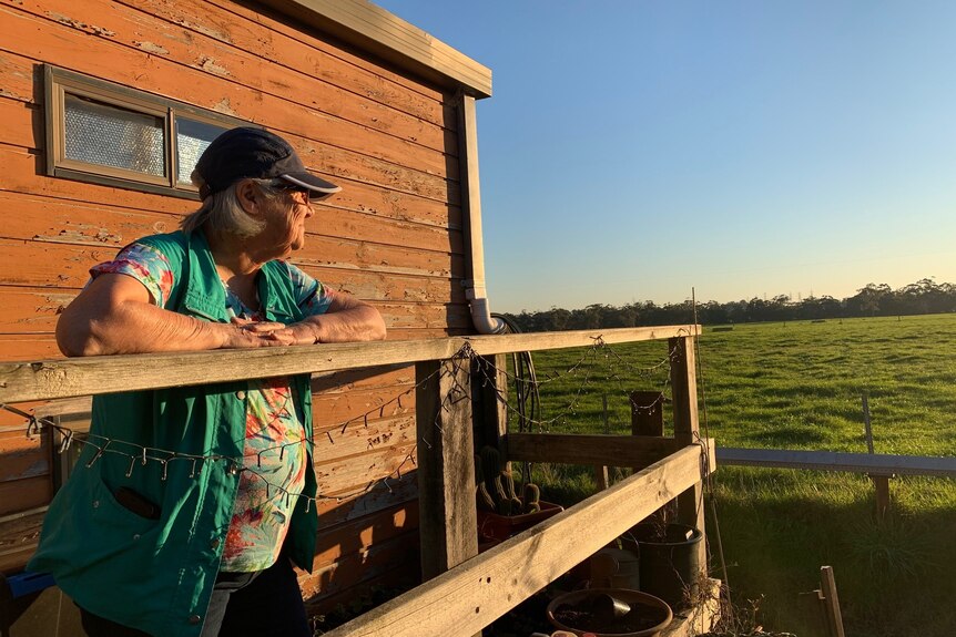woman looking out over her tiny home verandah