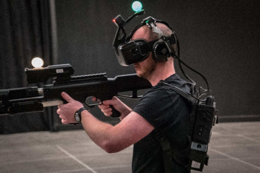 Man with VR headset and gun