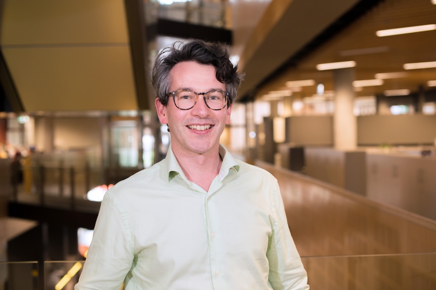 A man with glasses in a university.