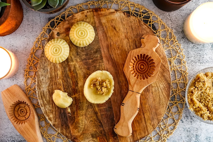 A wooden mould gives mamoul cookies a distinctive pattern before they are baked and served for Eid.