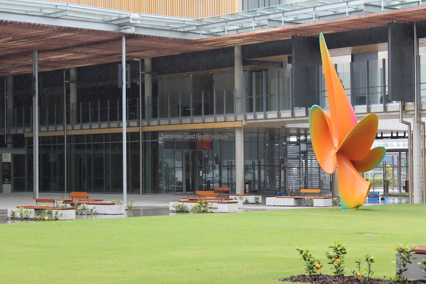 Large orange sculpture in a courtyard of the new hospital