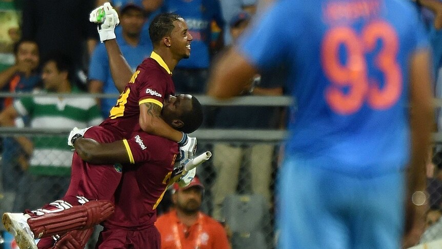 West Indies' Lendl Simmons celebrates with team-mate after their World T20 win over India.