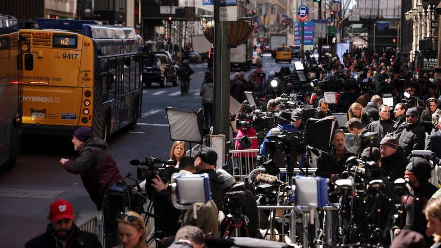 Members of the media wait outside Trump Tower as former US President Donald Trump is expected to arrive.