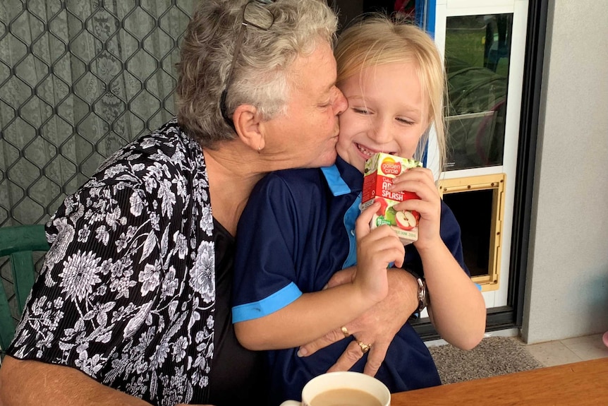 Sylvia hugs her granddaughter.