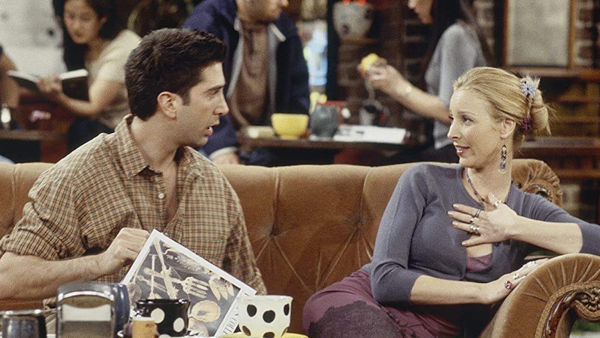 Ross and Phoebe sit on the couch at Central Perk, talking