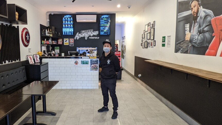 Naty Heng wears a mask in his empty Fairfield burger shop.