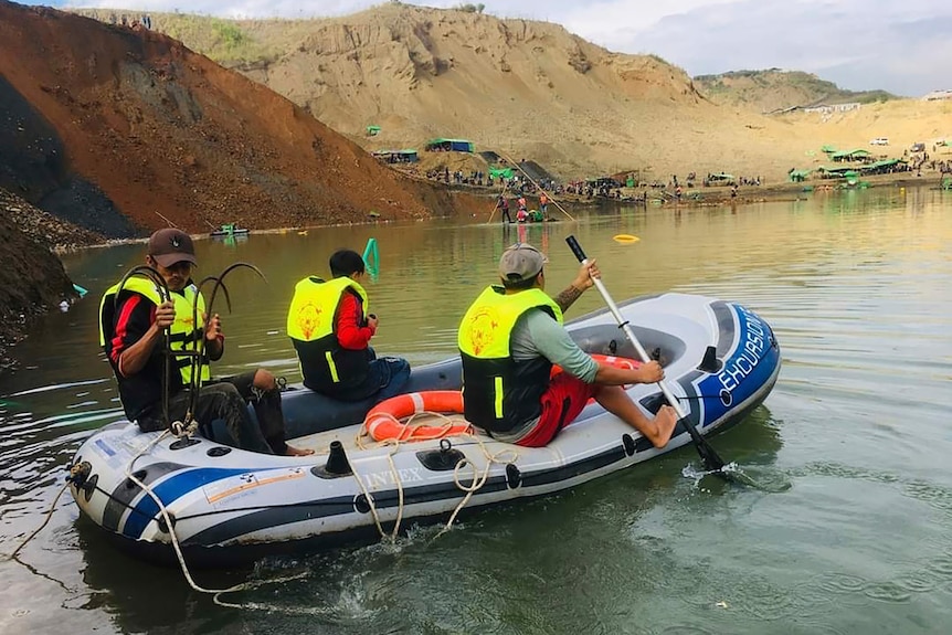 Members of rescue team search for missing people at a jade mining area