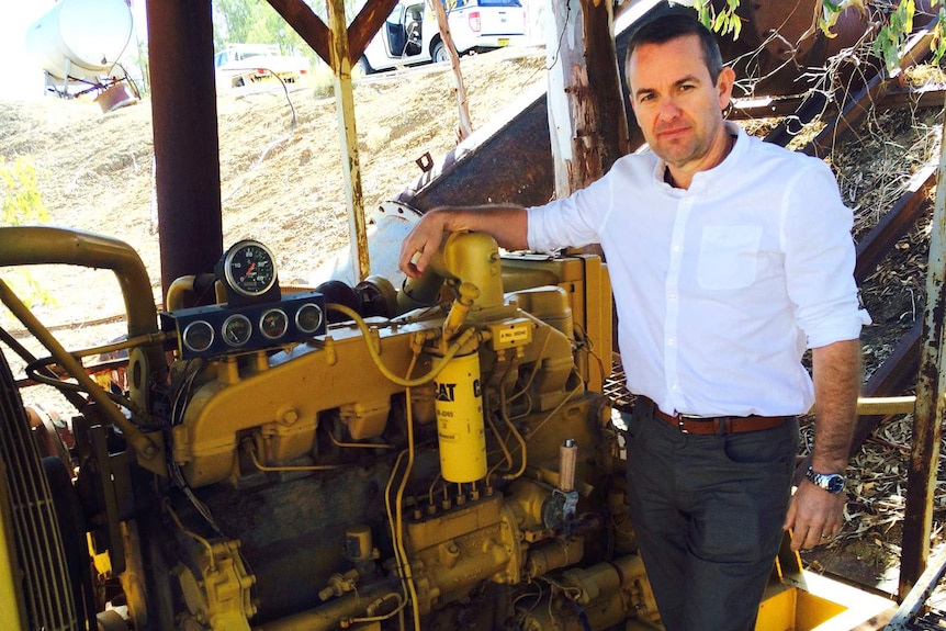 Water compliance executive Grant Barnes stands by an irrigation pump on the river at Bourke